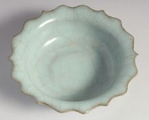 A SMALL CHINESE CELADON CRACKLE GLAZE PETAL FORM BOWL, 12cm diameter.