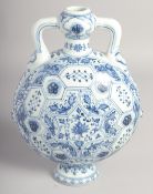 A CHINESE BLUE AND WHITE PORCELAIN TWIN HANDLED MOON FLASK decorated with lotus and further panels