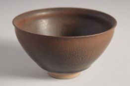 A CHINESE JIN WARE POTTERY BOWL, with hare's fur glaze, and carved characters to the base. 12.5cm