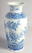 A CHINESE BLUE AND WHITE PORCELAIN VASE, the body finely painted with birds and native flora, the