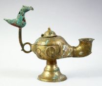AN ISLAMIC GILT BRONZE OIL LAMP, with lid and zoomorphic finial, 20cm long.