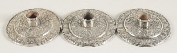 A SET OF THREE CHINESE SILVER CANDLESTICKS, bases 8.5cm diameter, (3).