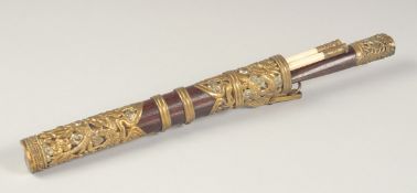 A TIBETAN HARDWOOD AND METAL MOUNTED TRAVELLING TROUSSE KNIFE AND CHOPSTICK SET, the sheath