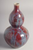 A SMALL CHINESE FLAMBE-TYPE GLAZE DOUBLE GOURD VASE, 19cm high.