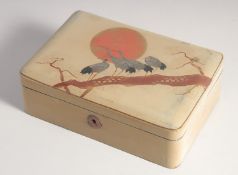 A JAPANESE LACQUERED WOOD BOX, the hinged lid decorated with cranes on a branch in the sunset with