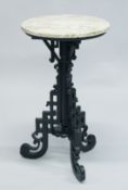 A GOOD CHINESE MARBLE TOP CARVED HARDWOOD STAND, supported on three carved and pierced legs,