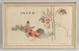 A 20TH CENTURY CHINESE EMBROIDERED SILK PANEL, depicting roosters, framed and glazed, 61cm 41.5cm.