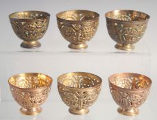 A VERY FINE SET OF SIX 18TH/19TH CENTURY OTTOMAN TURKISH GILDED COPPER TOMBAK OPENWORK ZARF CUPS,
