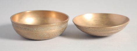 TWO FINE 19TH CENTURY PERSIAN QAJAR ENGRAVED BRASS DRINKING BOWLS, each 9.5cm diameter, (2).