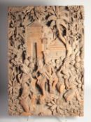 A FINE INDONESIAN CARVED WOOD PANEL, carved with figures and trees with an inscribed temple entrance