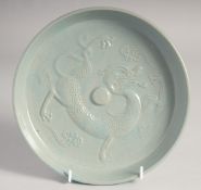 A CHINESE CELADON DRAGON DISH, 21cm diameter.