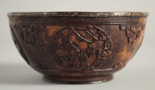 AN EARLY CHINESE CARVED COCONUT BOWL, possibly 17th century, the exterior with carved decorative