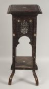A MOORISH TALL CARVED HARDWOOD STAND, with mother of pearl inlay and mashrabiya panels above a lower