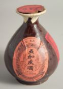 A CHINESE GLAZED POTTERY LIQUOR BOTTLE, (complete- containing liquid).