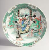A CHINESE FAMILLE VERTE PORCELAIN PLATE, painted with a female figures playing musical instruments