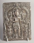 A 19TH CENTURY SOUTH INDIAN SILVER REPOUSSE PLAQUE OF SHIVA, Shiva depicted in the warrior form
