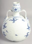A CHINESE BLUE AND WHITE PORCELAIN TWIN HANDLED MOON FLASK with carved central dragon. 29.5cm high