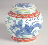 A CHINESE DOUCAI PORCELAIN JAR AND COVER, painted with dragons, Tian mark to base, 13cm high.