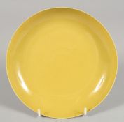 A CHINESE IMPERIAL YELLOW GLAZE PORCELAIN DISH, the base with incised six-character mark. 20cm