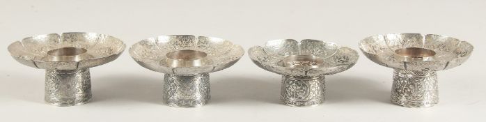 A SET OF FOUR CHINESE SILVER PEDESTAL DISHES, with engraved decoration and precious objects in
