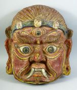 A LARGE TIBETAN CEREMONIAL PAPIER MACHE MASK, 43cm x 38cm.