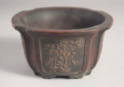 A CHINESE YIXING PLANT POT, decorated with relief flora, 16cm wide.