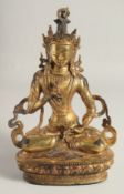 A GILT BRONZE FIGURE OF A SEATED DEITY, 29cm high.