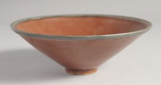 AN UNUSUAL CHINESE BROWN GLAZE POTTERY BOWL, 17.5cm diameter.