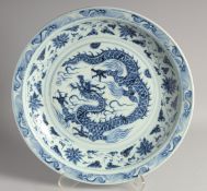 A VERY LARGE CHINESE BLUE AND WHITE PORCELAIN DRAGON CHARGER, the central dragon with a border of