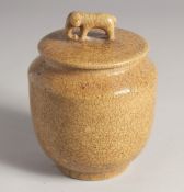 A CHINESE CRACKLE GLAZE JAR AND COVER, the cover with moulded elephant formed finial. 15cm high