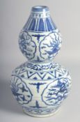 A LARGE CHINESE BLUE AND WHITE PORCELAIN DOUBLE GOURD VASE decorated with panels of dragon and