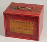 A RED LACQUER MAHJONG BOX with carrying handles, sliding front, and five drawers. 9