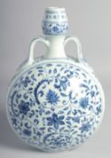 A CHINESE BLUE AND WHITE PORCELAIN TWIN HANDLED MOON FLASK painted with various flower heads and