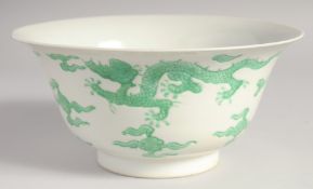 A CHINESE PORCELAIN DRAGON BOWL, the exterior with carved dragon and cloud decoration in green, 19.