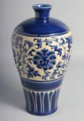 A CHINESE SACRIFICIAL BLUE GLAZED MEIPING VASE with carved flower head and vine decoration to the
