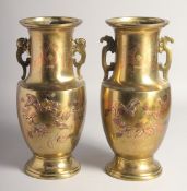 A PAIR OF JAPANESE BRASS TWIN HANDLE VASES, with relief decoration depicting birds and flora, 33cm