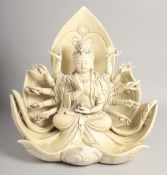 A CHINESE DEHUA PORCELAIN GUANYIN sitting on a large lotus throne, the reverse signed within a
