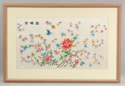 A LARGE 20TH CENTURY CHINESE EMBROIDERED SILK HUNDRED BUTTERFLY PANEL, framed and glazed, 67cm x