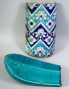 TWO ISLAMIC GLAZED RIDGE TILES, one with a turquoise glaze, the other decorated with floral