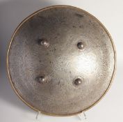A LARGE PERSIAN QAJAR STEEL SHIELD, with calligraphic panels and four raised bosses, 48cm diameter.