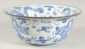 A LARGE CHINESE BLUE AND WHITE PORCELAIN BOWL, painted with dragons amongst stylised flames and