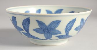 A CHINESE BLUE AND WHITE PORCELAIN BOWL decorated with large central flower head and further foliate