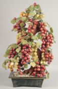 A VERY LARGE CHINESE HARDSTONE GRAPE TREE CLUSTER, in a rectangular planter, including carved