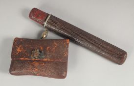A JAPANESE TOBACCO PIPE SET; comprising pipe, wood and red lacquer case, and leather tobacco pouch