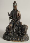 A CHINESE BRONZE FIGURE OF GUANYIN seated on an elephant, 26cm high.