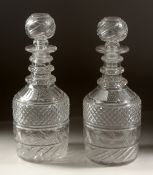 A PAIR OF HOBNAIL CUT DECANTERS AND STOPPERS.