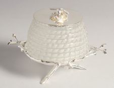 A SILVER PLATED AND GLASS HONEY POT.