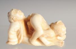 A CARVED BONE EROTIC NETSUKE. 2ins long.