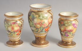 A GARNITURE OF THREE WEDGWOOD VASES painted with panels of fruit. 7.5ins x 6ins high, mark: