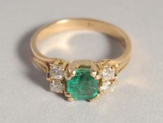 AN 18CT GOLD EMERALD AND DIAMOND RING.